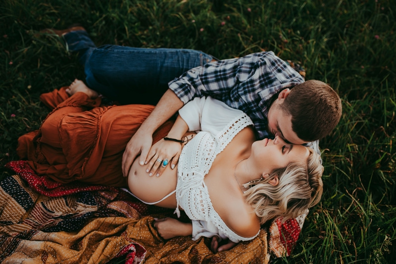 Wellsville NY Family & Newborn Photographer, couple laying down in the grass together