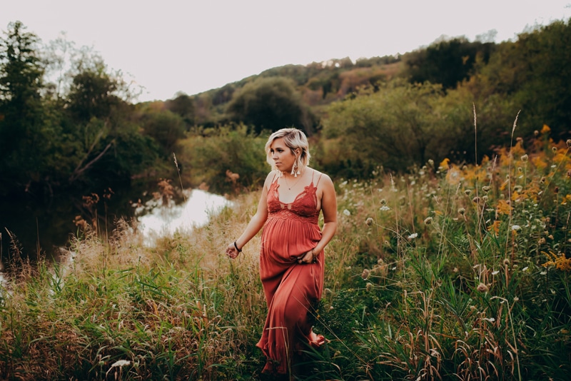 Wellsville NY Family & Newborn Photographer, pregnant woman walking in tall grass with red dress