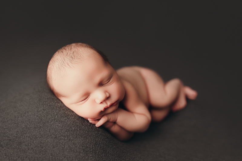 Wellsville NY Family & Newborn Photographer, baby sleeping on dark brown fabric