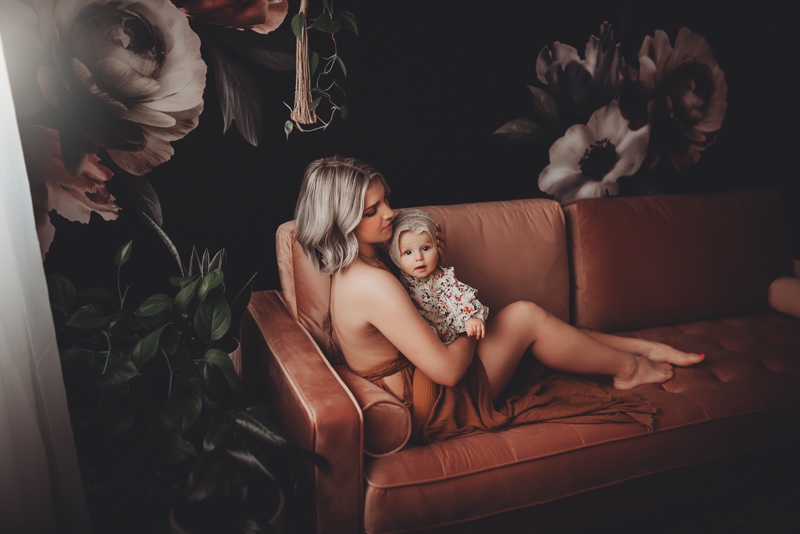 Wellsville NY Family & Newborn Photographer, mother and baby daughter cuddled up on couch