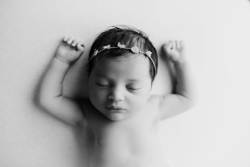 Wellsville NY Family & Newborn Photographer, black and white of baby sleep with arms out