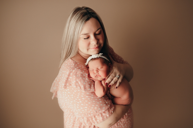 Wellsville NY Family & Newborn Photographer, mother holding newborn baby on her shoulder