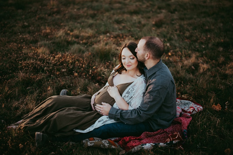 Wellsville NY Family and Newborn Photographer, couple sitting in the grass