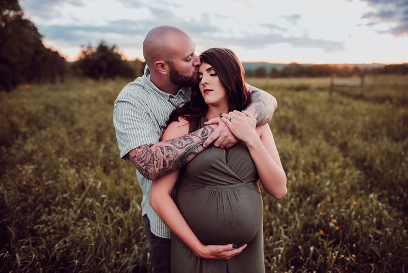 Wellsville NY Family & Newborn Photographer, man kissing pregnant woman's forehead