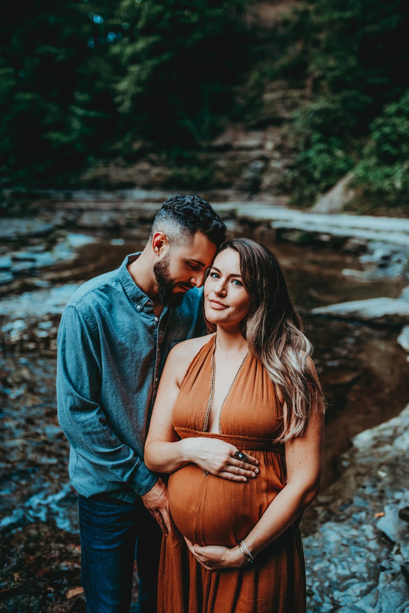 Wellsville NY Family and Newborn Photographer, couple posing next to a creek