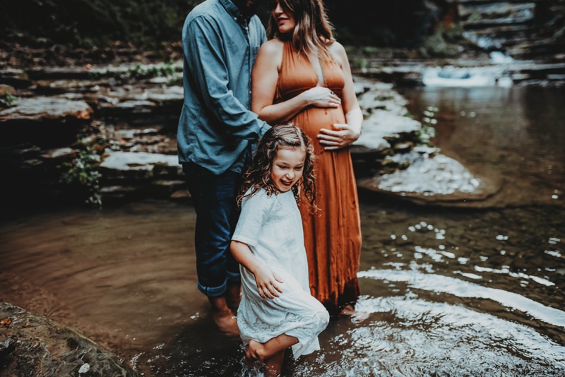 Wellsville NY Family and Newborn Photographer, family of three standing in creek