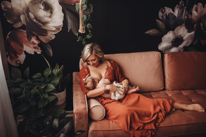 Wellsville NY Family and Newborn Photographer, mother breastfeeding baby on couch
