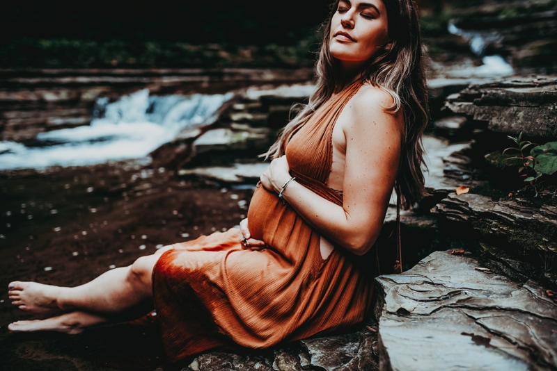Wellsville NY Family and Newborn Photographer, close up of woman sitting in creek